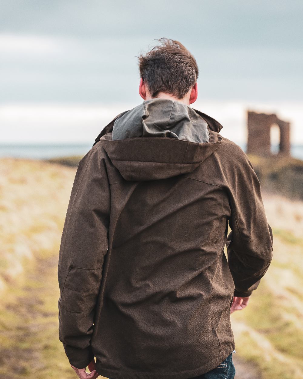 Dark Green coloured Hoggs of Fife Struther Waterproof Lightweight Jacket on sky background