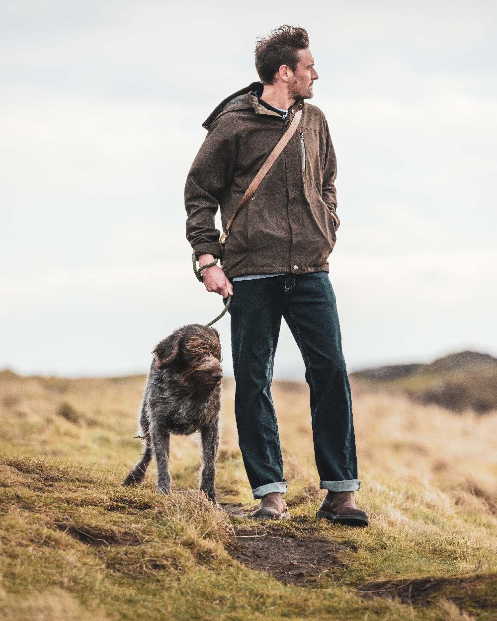 Dark Green coloured Hoggs of Fife Struther Waterproof Lightweight Jacket on mountain background