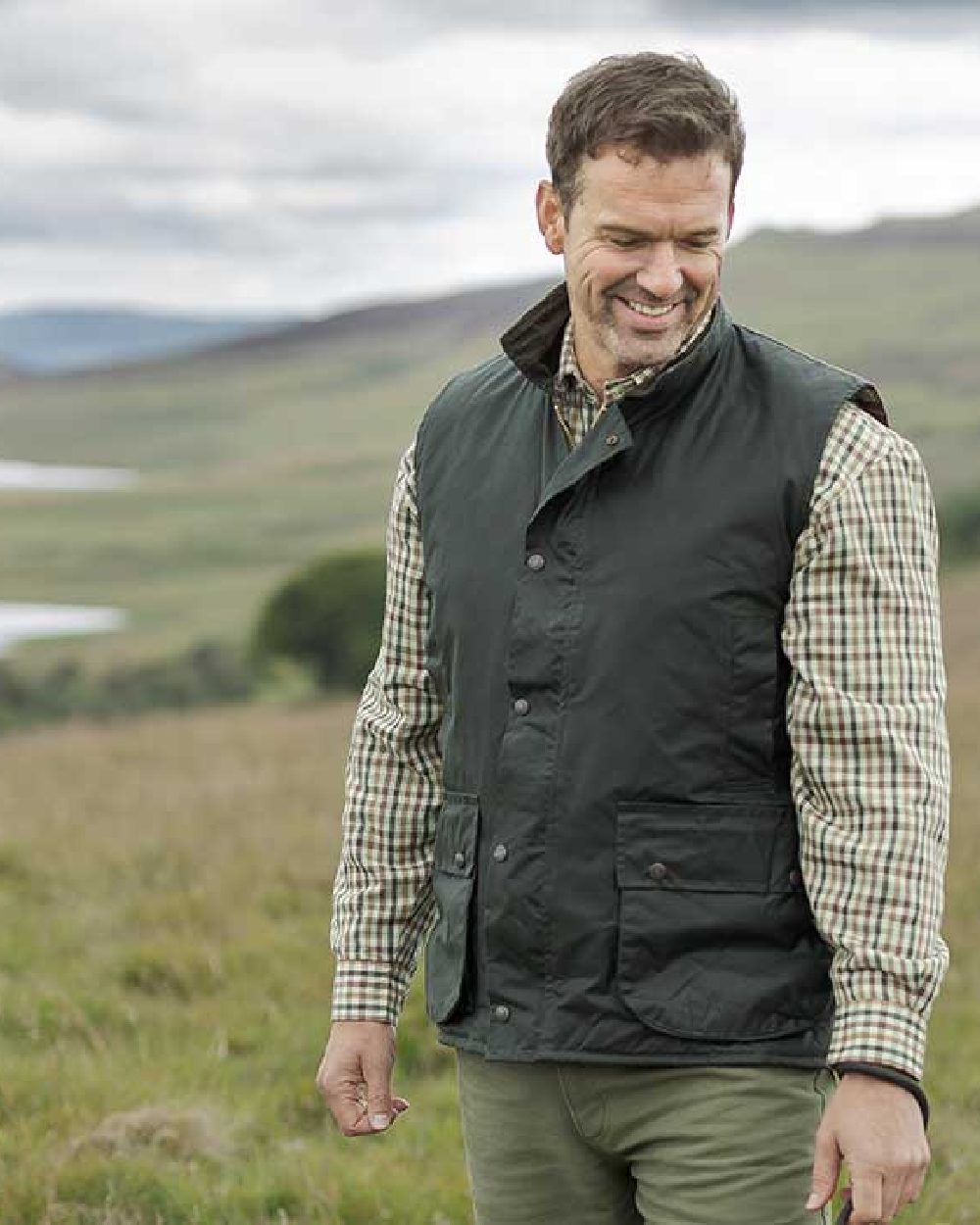 Olive Coloured Hoggs of Fife Waxed Waistcoat on mountain background