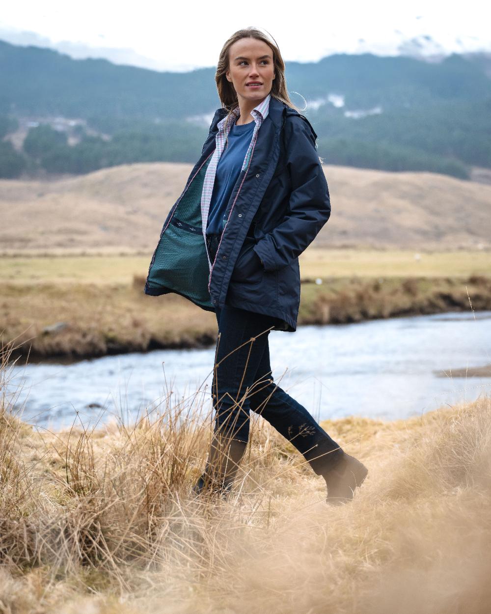 Navy Coloured Hoggs of Fife Womens Fara Waterproof Jacket on countryside background