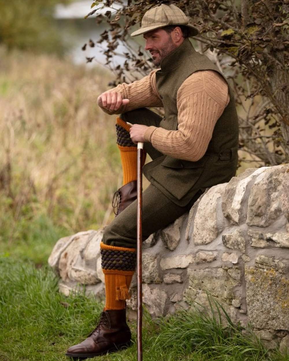 Ochre coloured House of Cheviot Angus Socks on field background