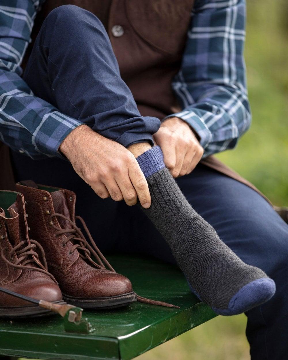 Charcoal St Andrews Blue coloured House of Cheviot Glen Technical Socks on blurry background