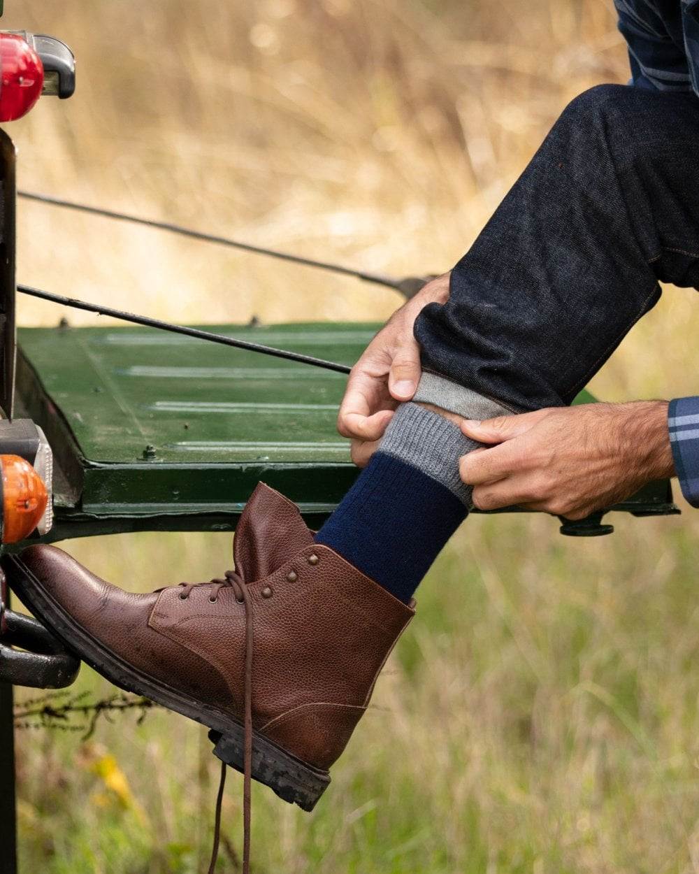 Navy Mid Grey coloured House of Cheviot Glen Technical Socks on blurry background