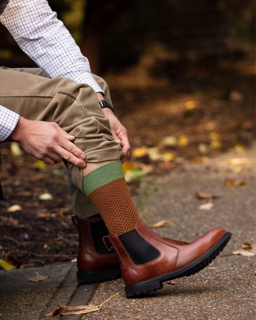 Ivy Green coloured House of Cheviot Herringbone Short Socks on blurry background