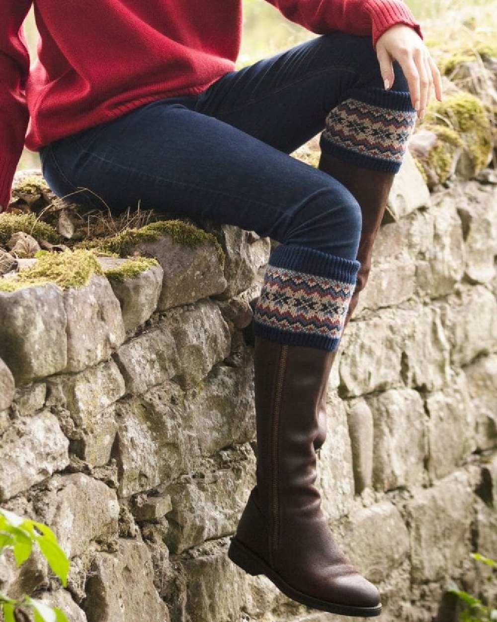 Navy coloured House of Cheviot Lady Fairsle Socks on stone wall background