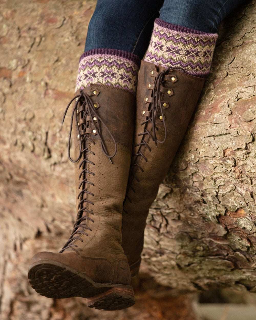 Thistle coloured House of Cheviot Lady Fairsle Socks on stone wall background