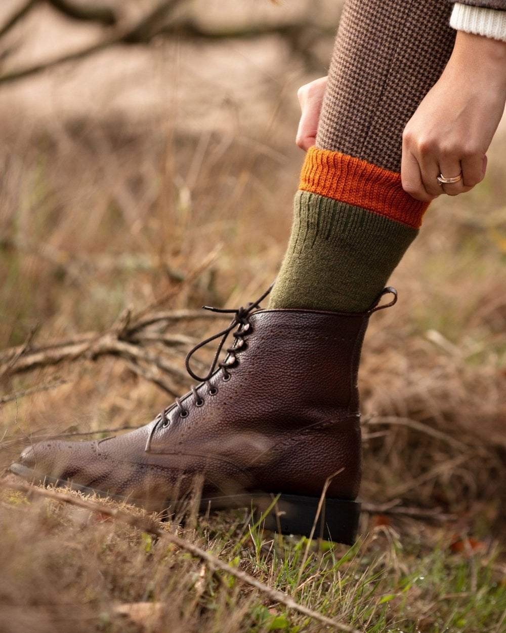 Dark Olive Burnt Orange coloured House of Cheviot Lady Glen Socks on blurry background