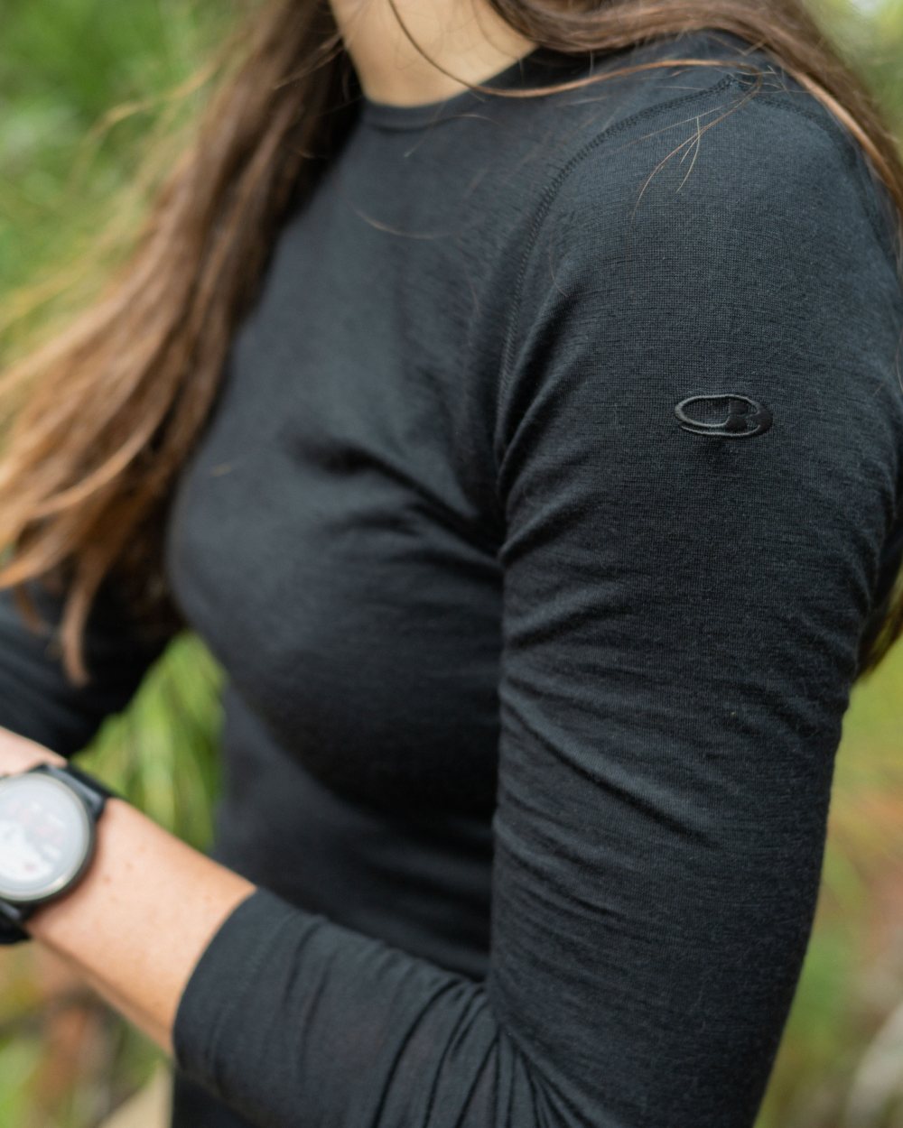 Black Coloured Icebreaker Womens Merino 200 Oasis Crewe Thermal Top on forest background