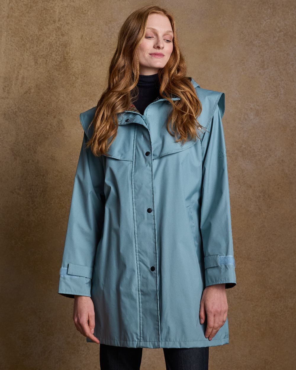 Smoke Blue Coloured Jack Murphy Cotswold Ladies Waterproof 3/4 Coat on indoor background