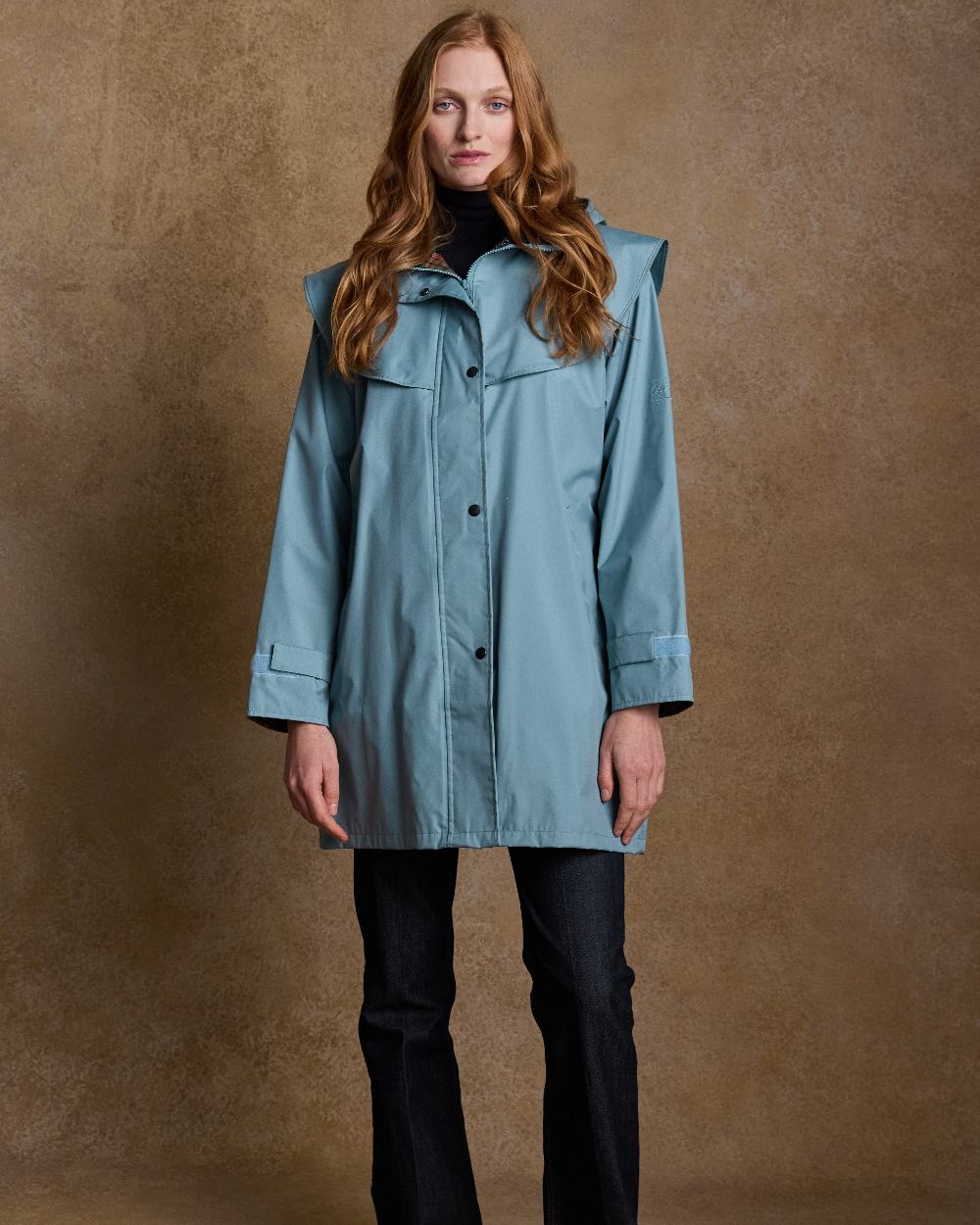 Smoke Blue Coloured Jack Murphy Cotswold Ladies Waterproof 3/4 Coat on indoor background