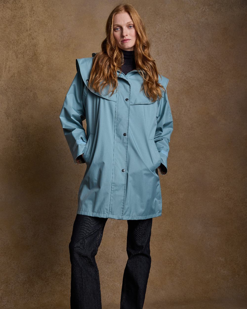 Smoke Blue Coloured Jack Murphy Cotswold Ladies Waterproof 3/4 Coat on indoor background