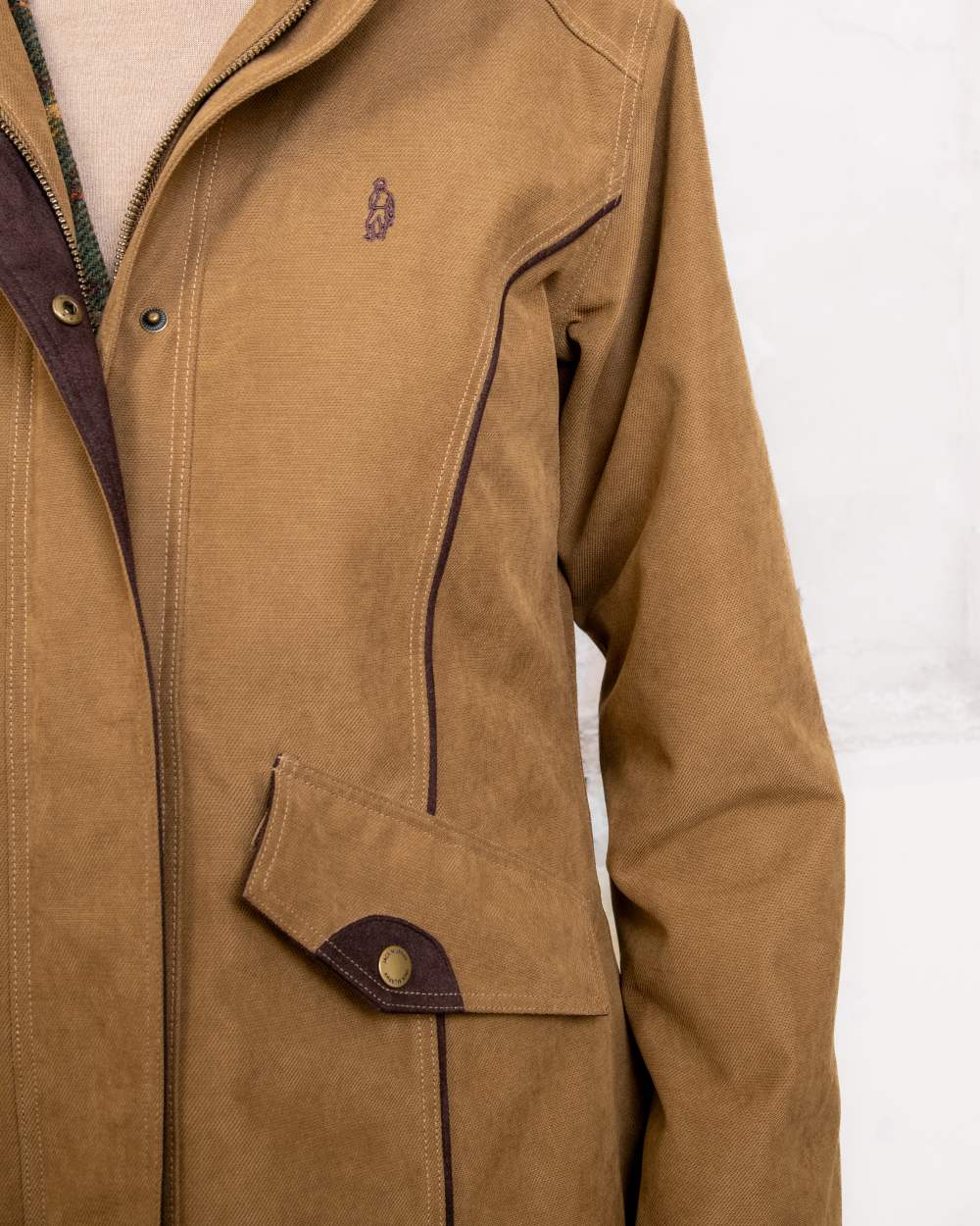 Camel coloured Jack Murphy Erin Long Waterproof Coat on wall background