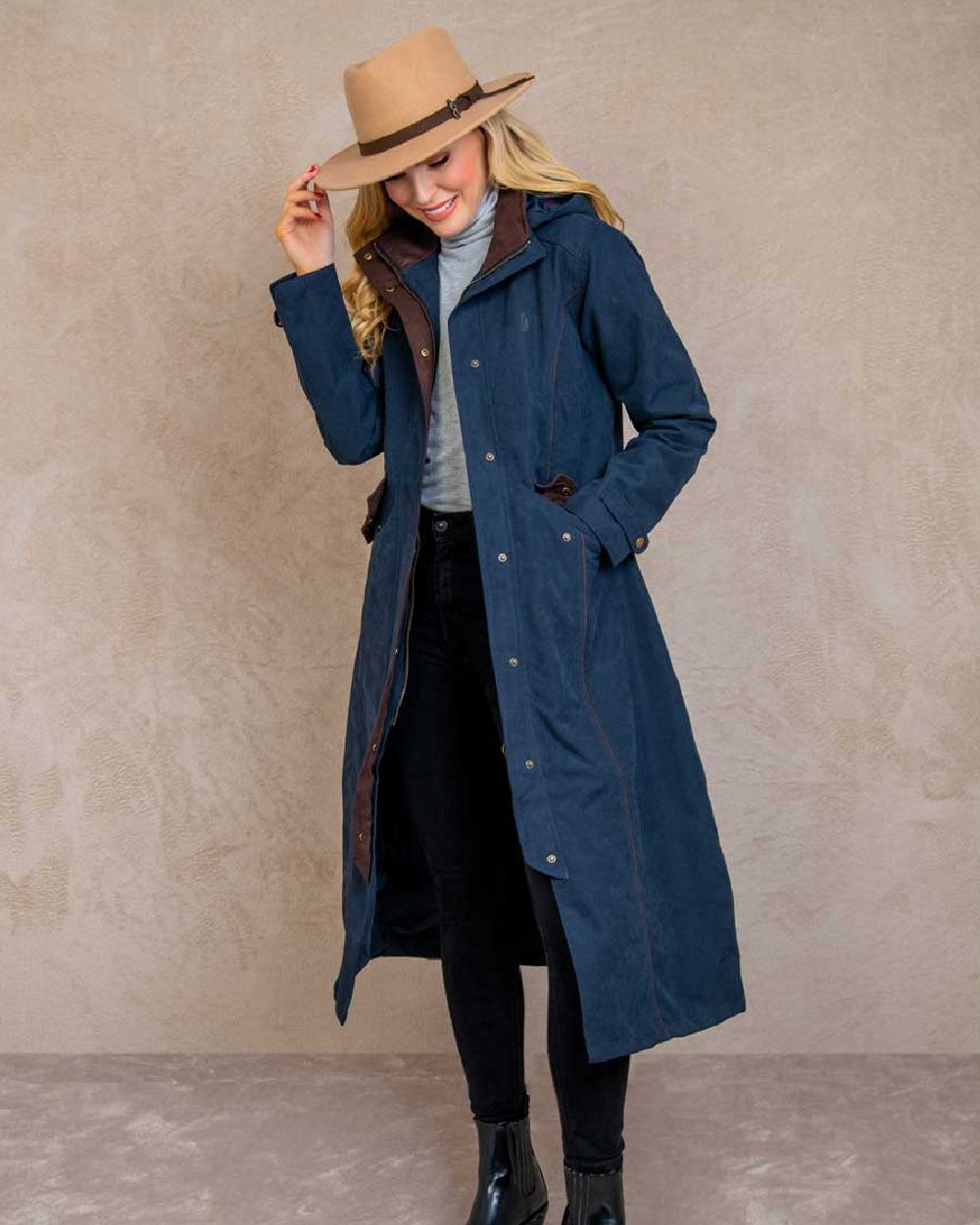 Heritage Navy coloured Jack Murphy Erin Long Waterproof Coat on wall background