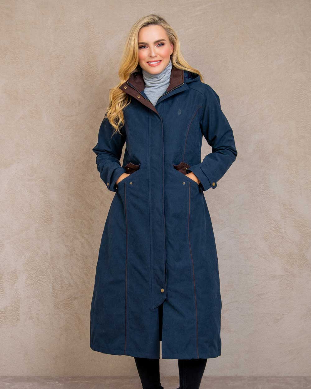 Heritage Navy coloured Jack Murphy Erin Long Waterproof Coat on wall background