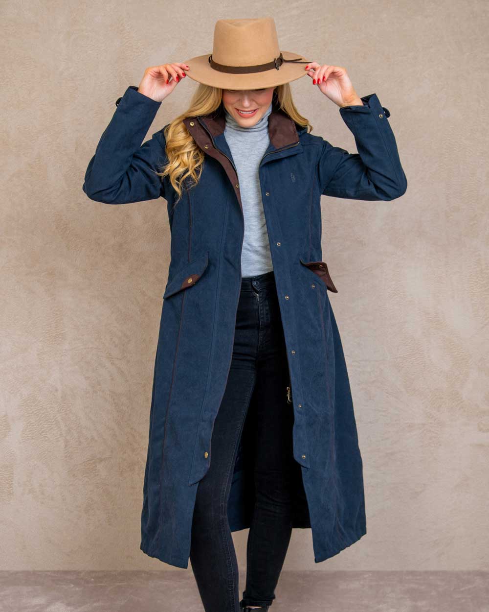 Heritage Navy coloured Jack Murphy Erin Long Waterproof Coat on wall background