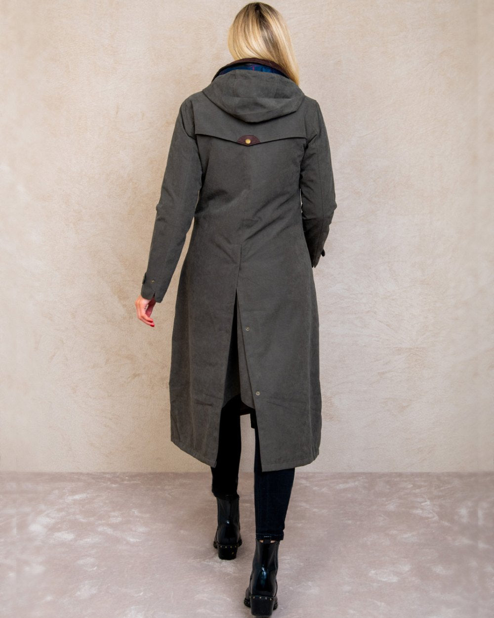 Olive coloured Jack Murphy Erin Long Waterproof Coat on wall background