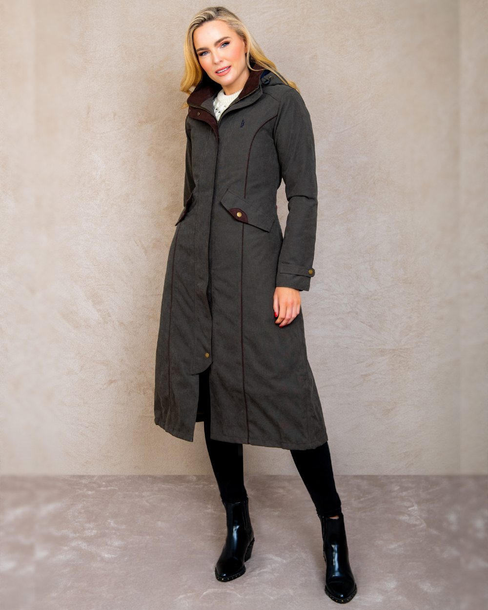 Olive coloured Jack Murphy Erin Long Waterproof Coat on wall background