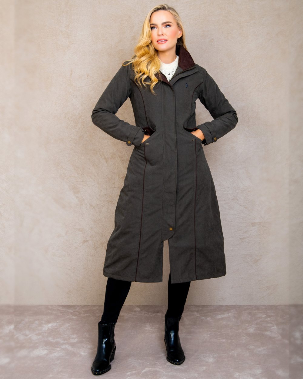 Olive coloured Jack Murphy Erin Long Waterproof Coat on wall background