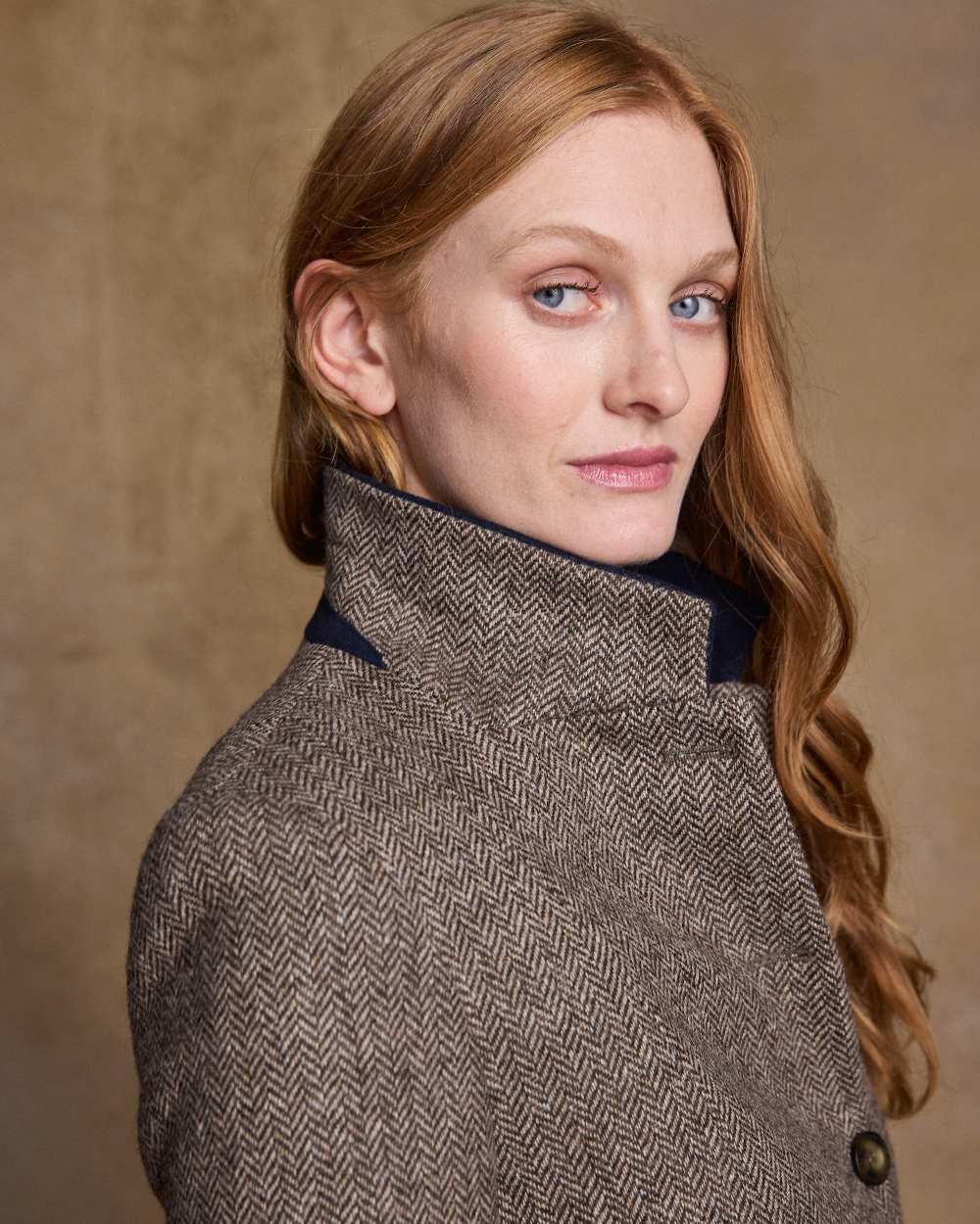 Light Tan Herringbone Coloured Jack Murphy Isabella Tweed Coat on indoor background