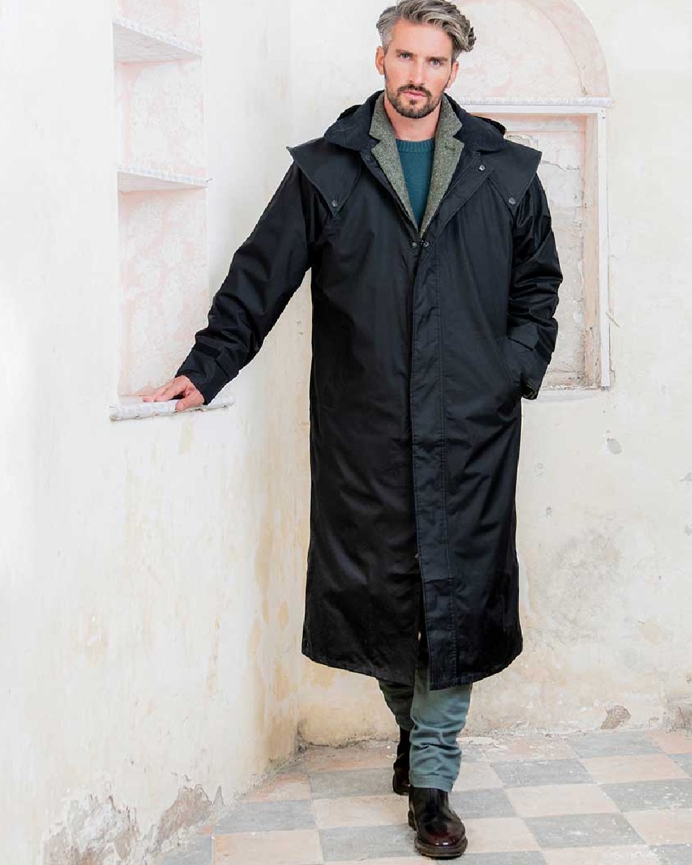 Black coloured Jack Murphy Lambourne Mens Long Bush Coat on wall background