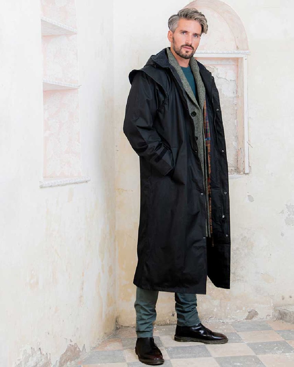 Black coloured Jack Murphy Lambourne Mens Long Bush Coat on wall background