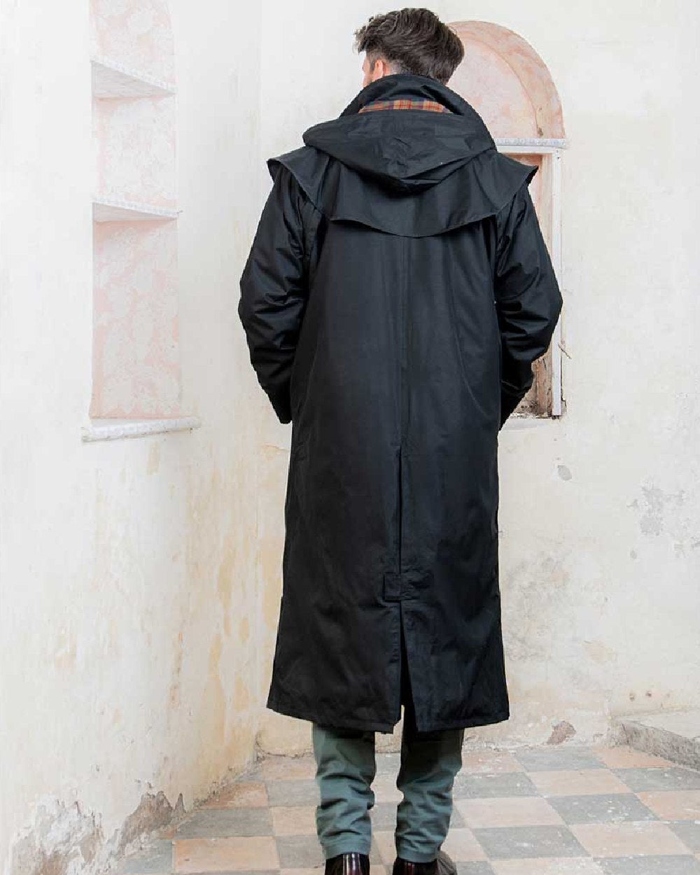 Black coloured Jack Murphy Lambourne Mens Long Bush Coat on wall background