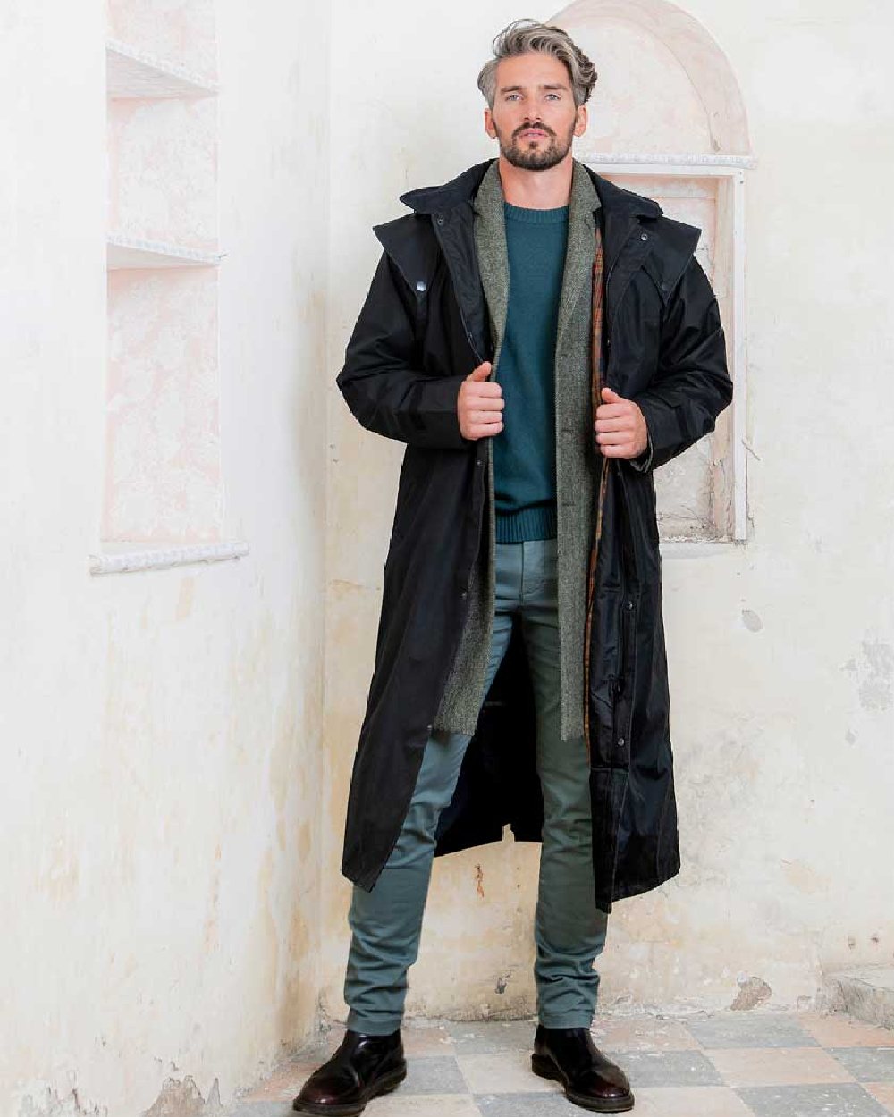Black coloured Jack Murphy Lambourne Mens Long Bush Coat on wall background