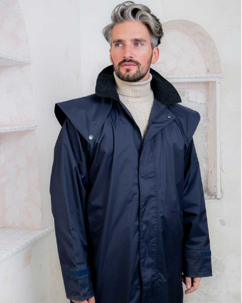 Navy coloured Jack Murphy Lambourne Mens Long Bush Coat on wall background