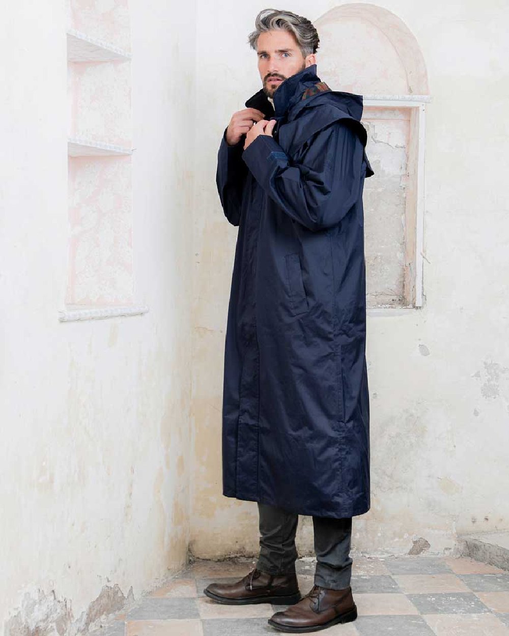 Navy coloured Jack Murphy Lambourne Mens Long Bush Coat on wall background