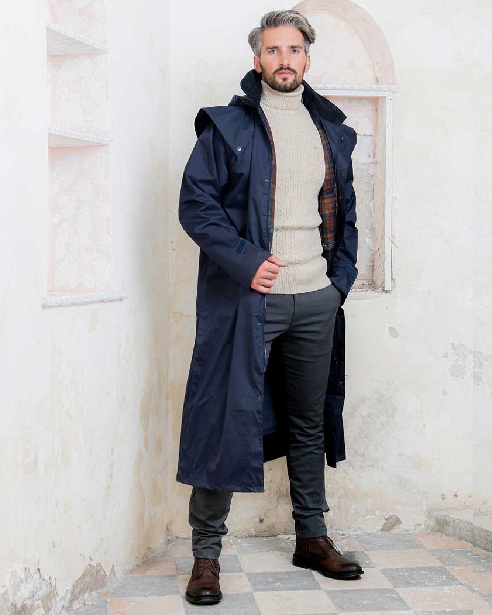 Navy coloured Jack Murphy Lambourne Mens Long Bush Coat on wall background