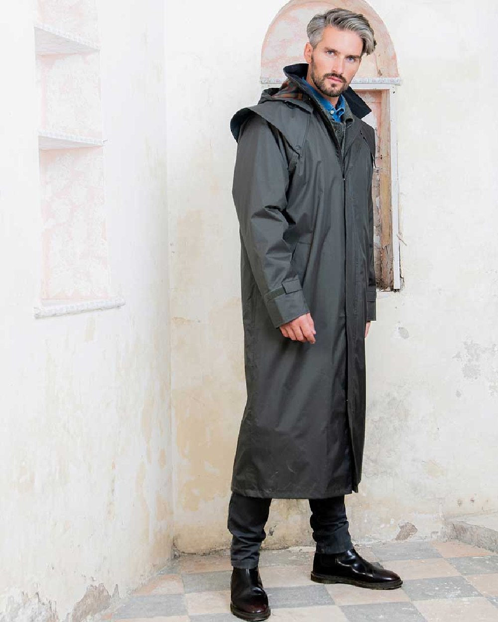 Olive coloured Jack Murphy Lambourne Mens Long Bush Coat on wall background