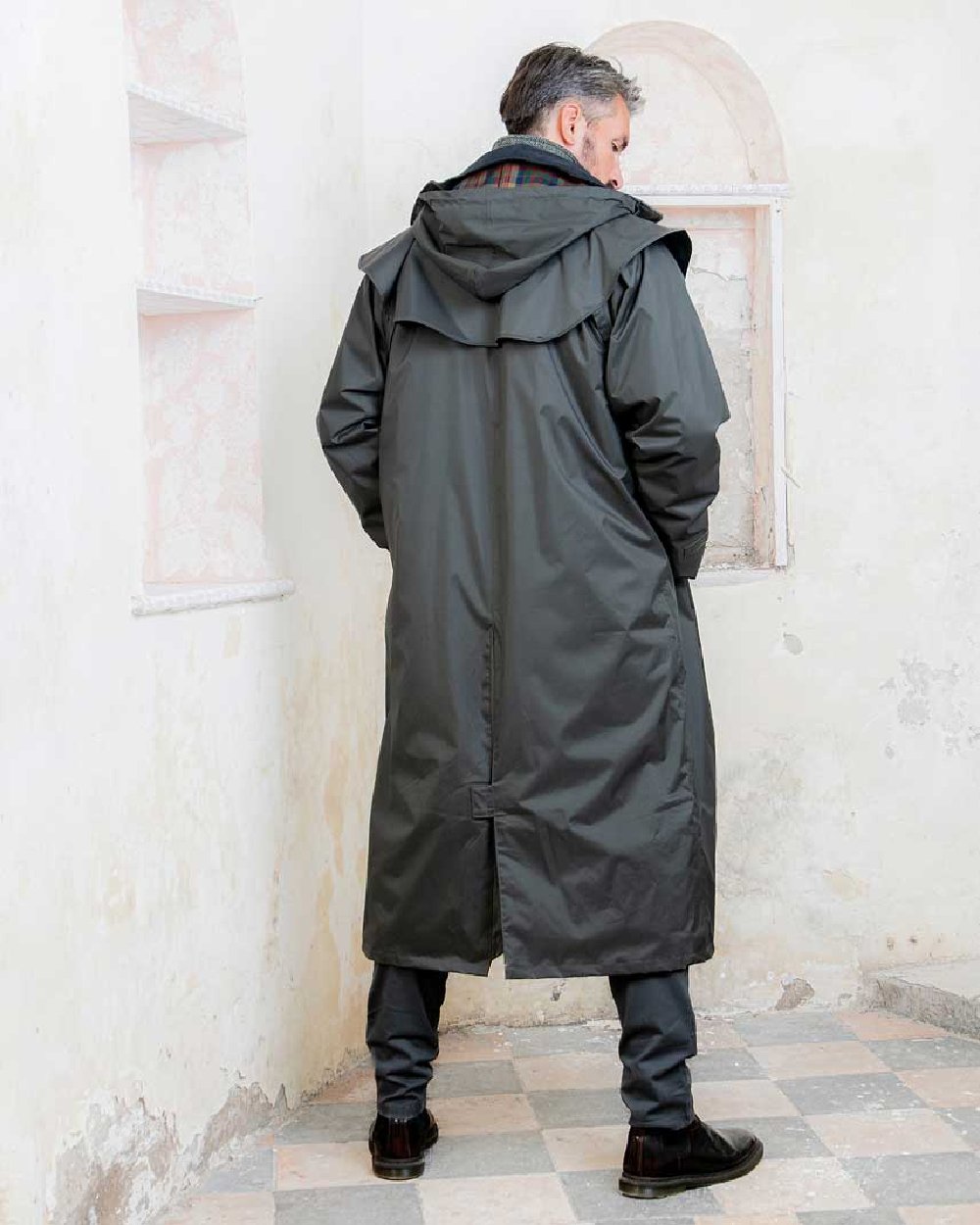 Olive coloured Jack Murphy Lambourne Mens Long Bush Coat on wall background