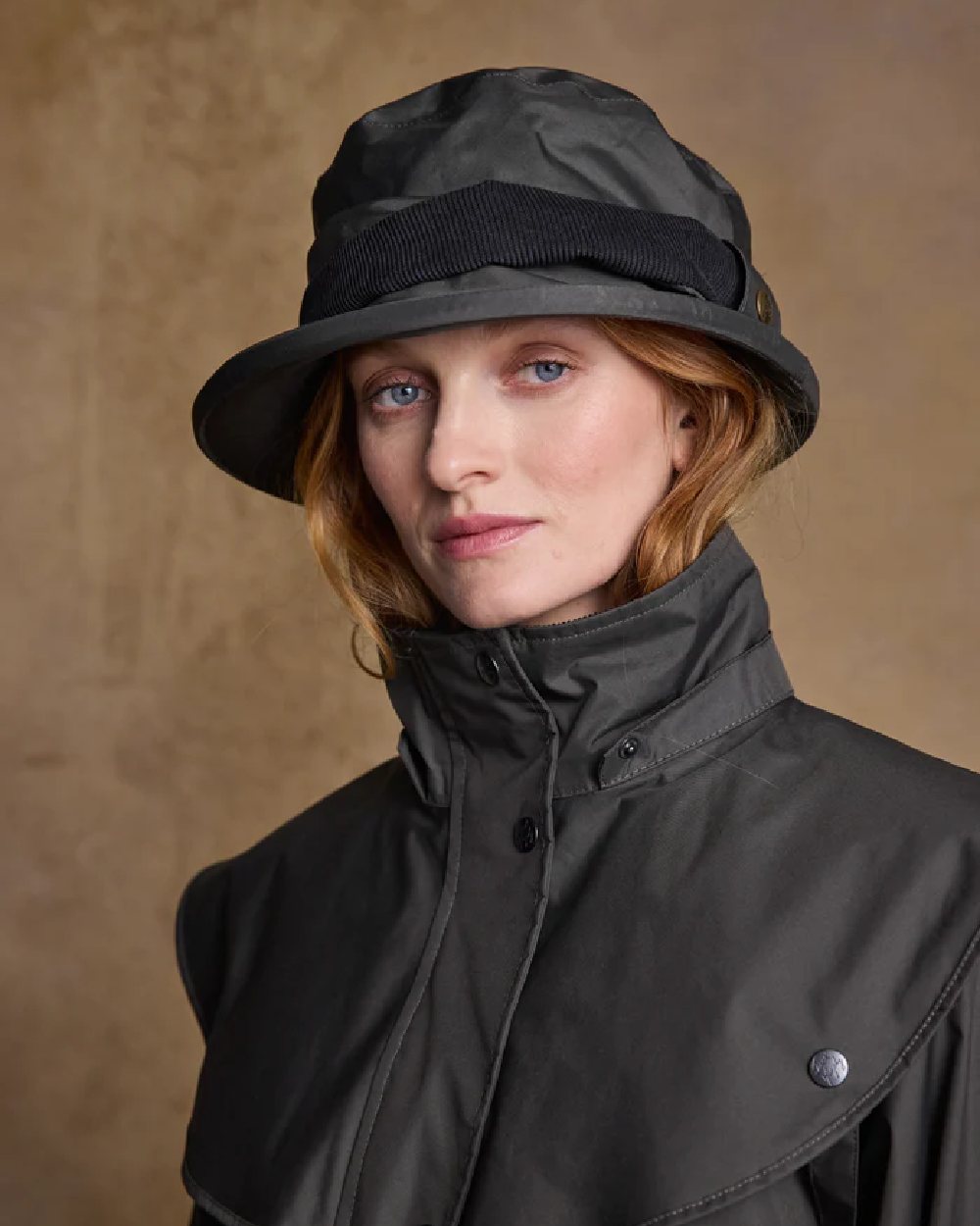 Olive coloured Jack Murphy Malvern Heritage Rain Hat on wall background