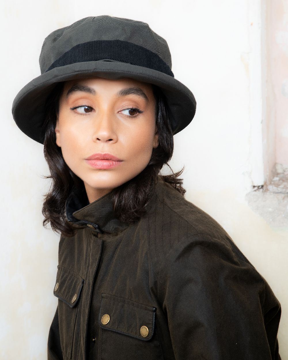 Olive coloured Jack Murphy Malvern Heritage Rain Hat on wall background