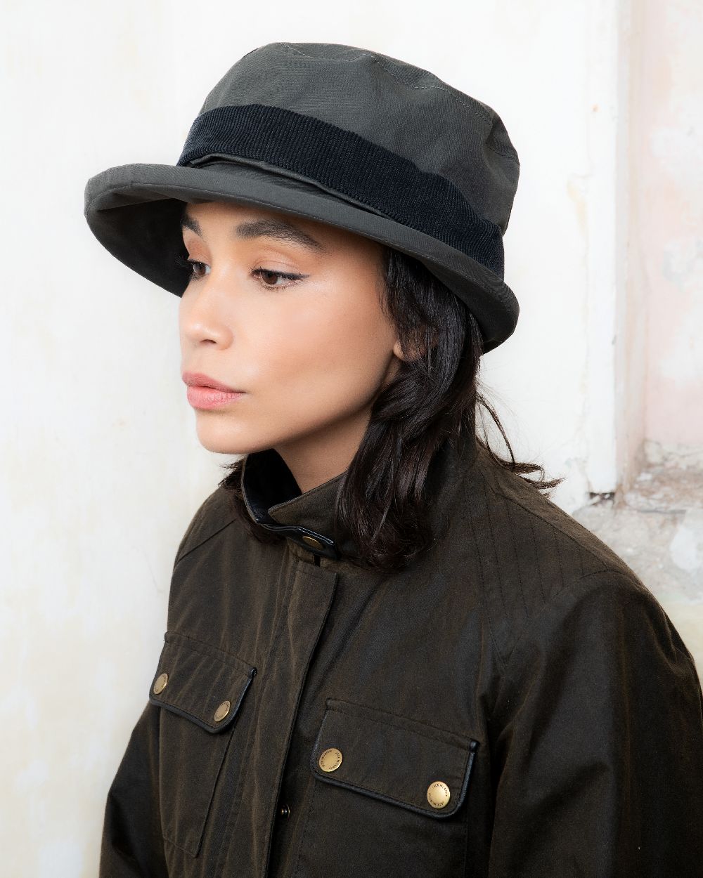 Olive coloured Jack Murphy Malvern Heritage Rain Hat on wall background