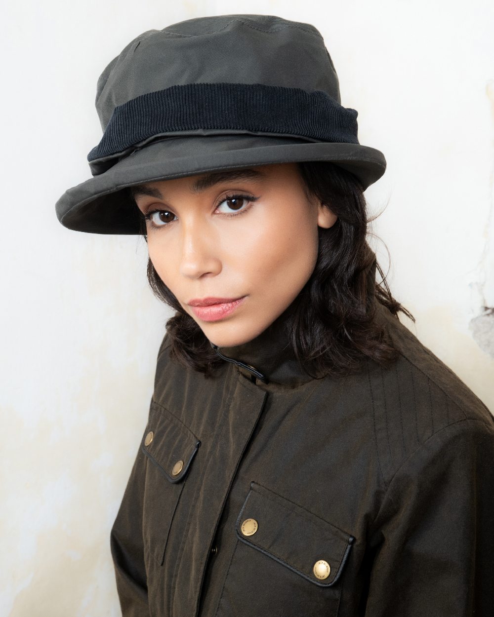 Olive coloured Jack Murphy Malvern Heritage Rain Hat on wall background