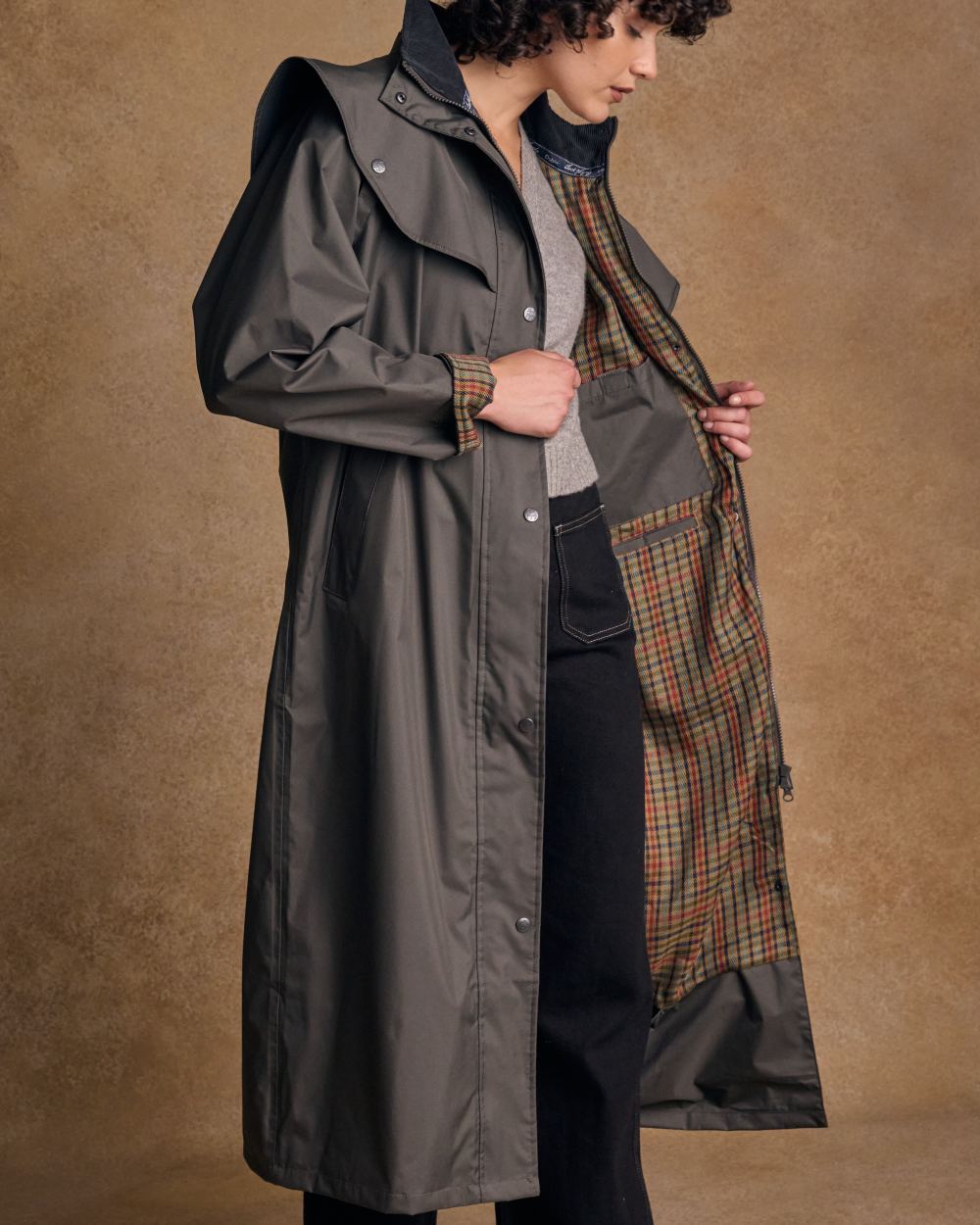 Olive coloured Jack Murphy Malvern Ladies Waterproof Bush Coat on wall background