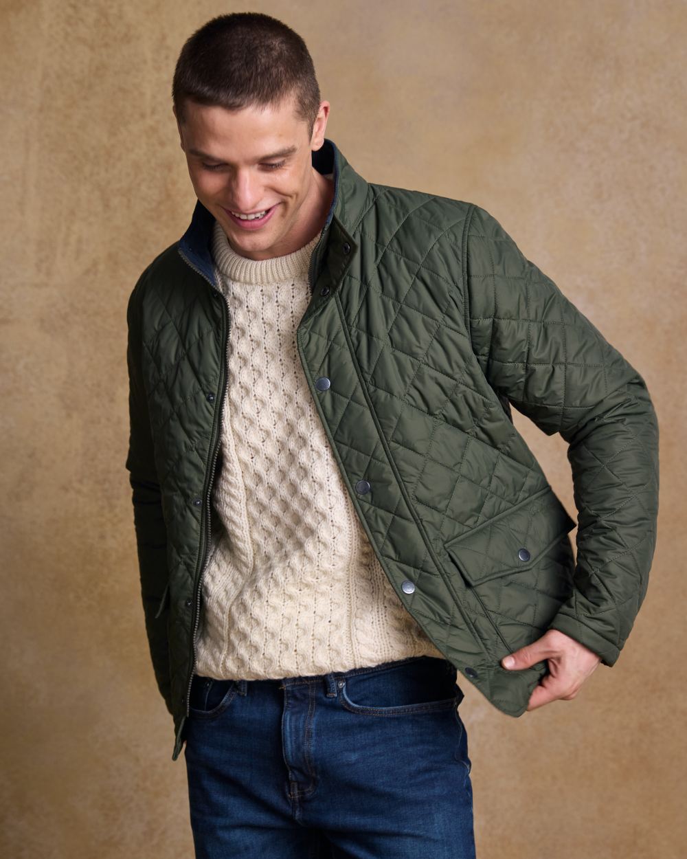 Olive coloured Jack Murphy Ronan Quilted Jacket on wall background