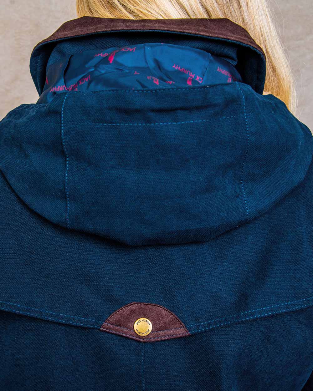 Heritage Navy coloured Jack Murphy Una 3/4 Waterproof Coat on wall background