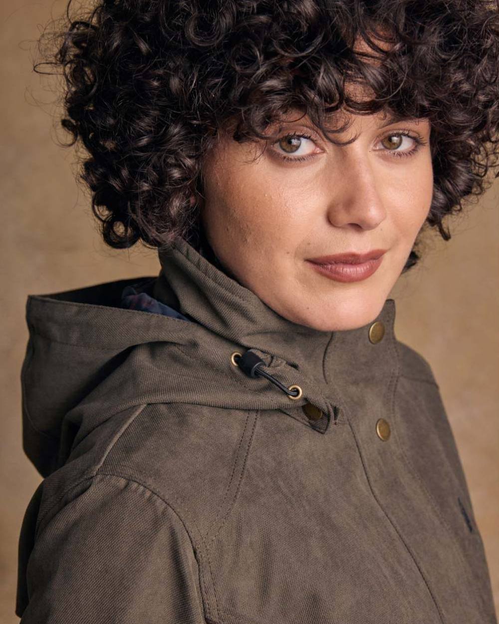 Olive coloured Jack Murphy Una 3/4 Waterproof Coat on wall background