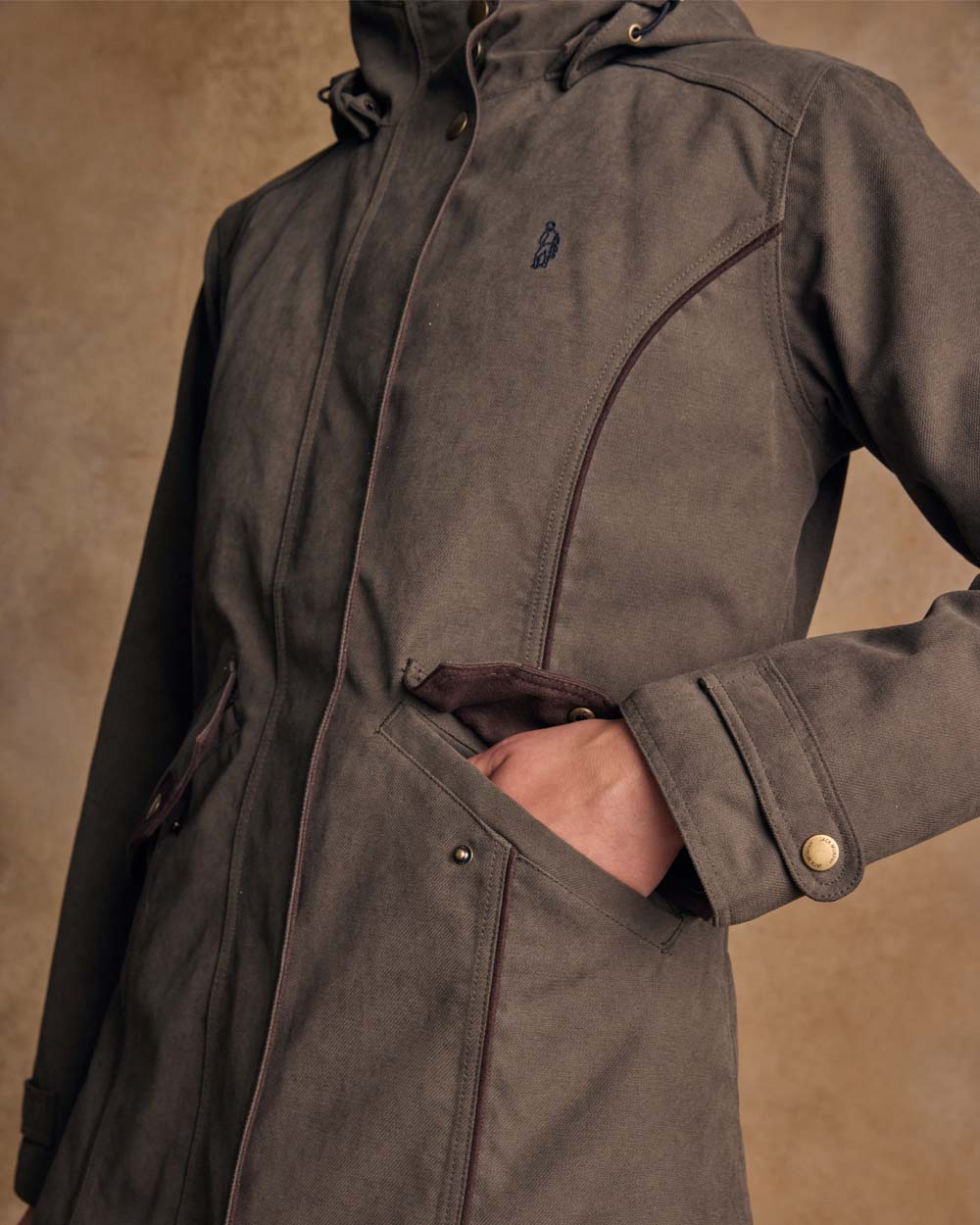 Olive coloured Jack Murphy Una 3/4 Waterproof Coat on wall background