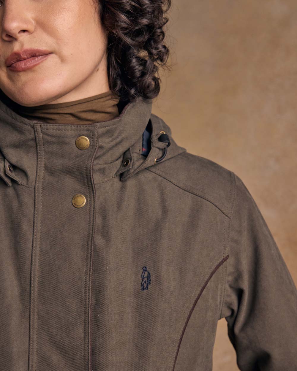 Olive coloured Jack Murphy Una 3/4 Waterproof Coat on wall background