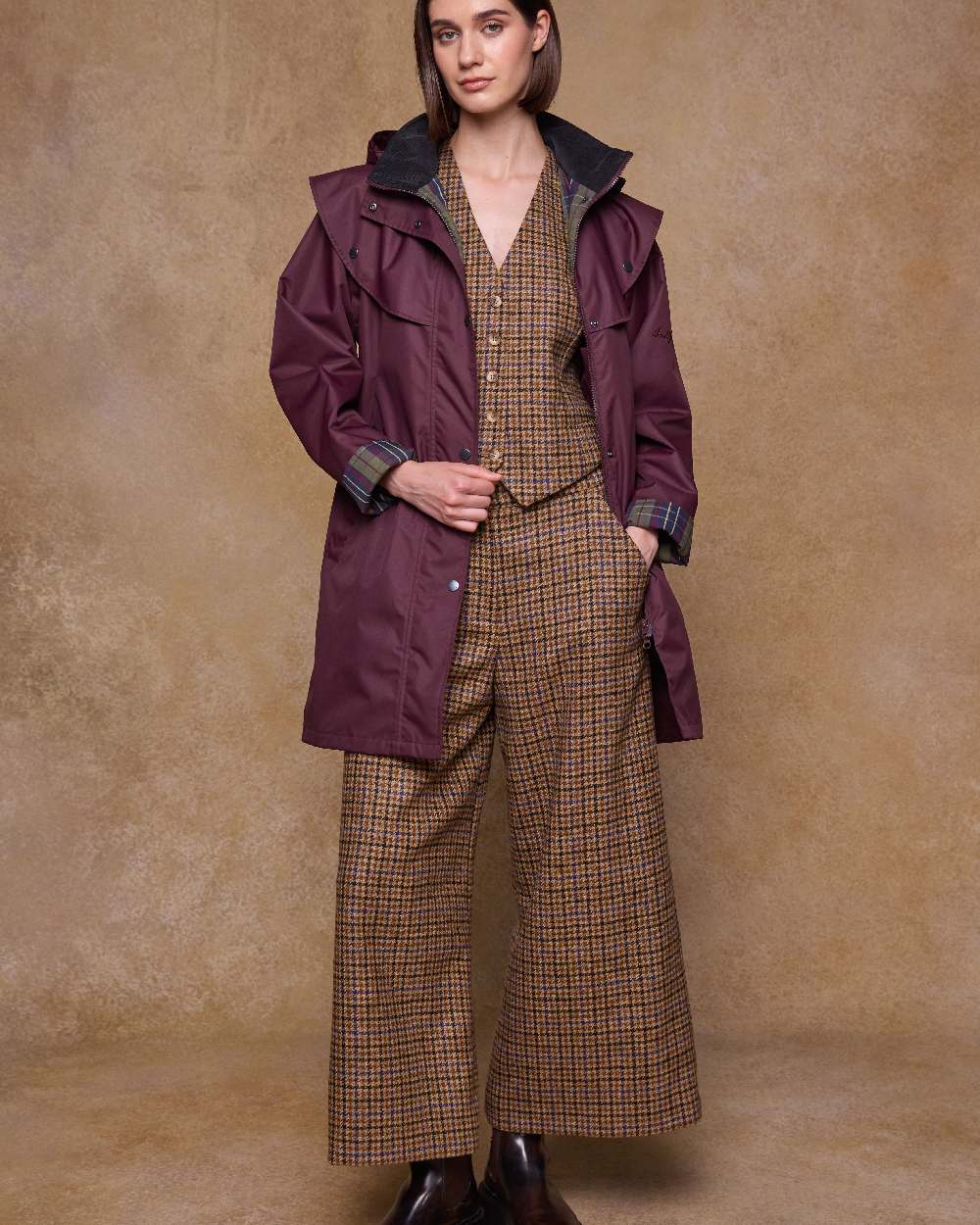 Deep Claret Coloured Jack Murphy Womens Dingle Waterproof Jacket on indoor background