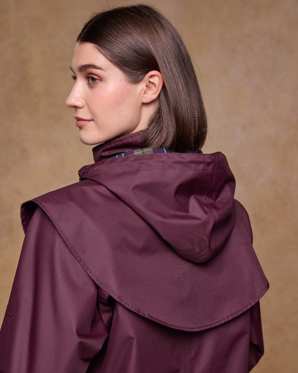 Deep Claret Coloured Jack Murphy Womens Dingle Waterproof Jacket on indoor background