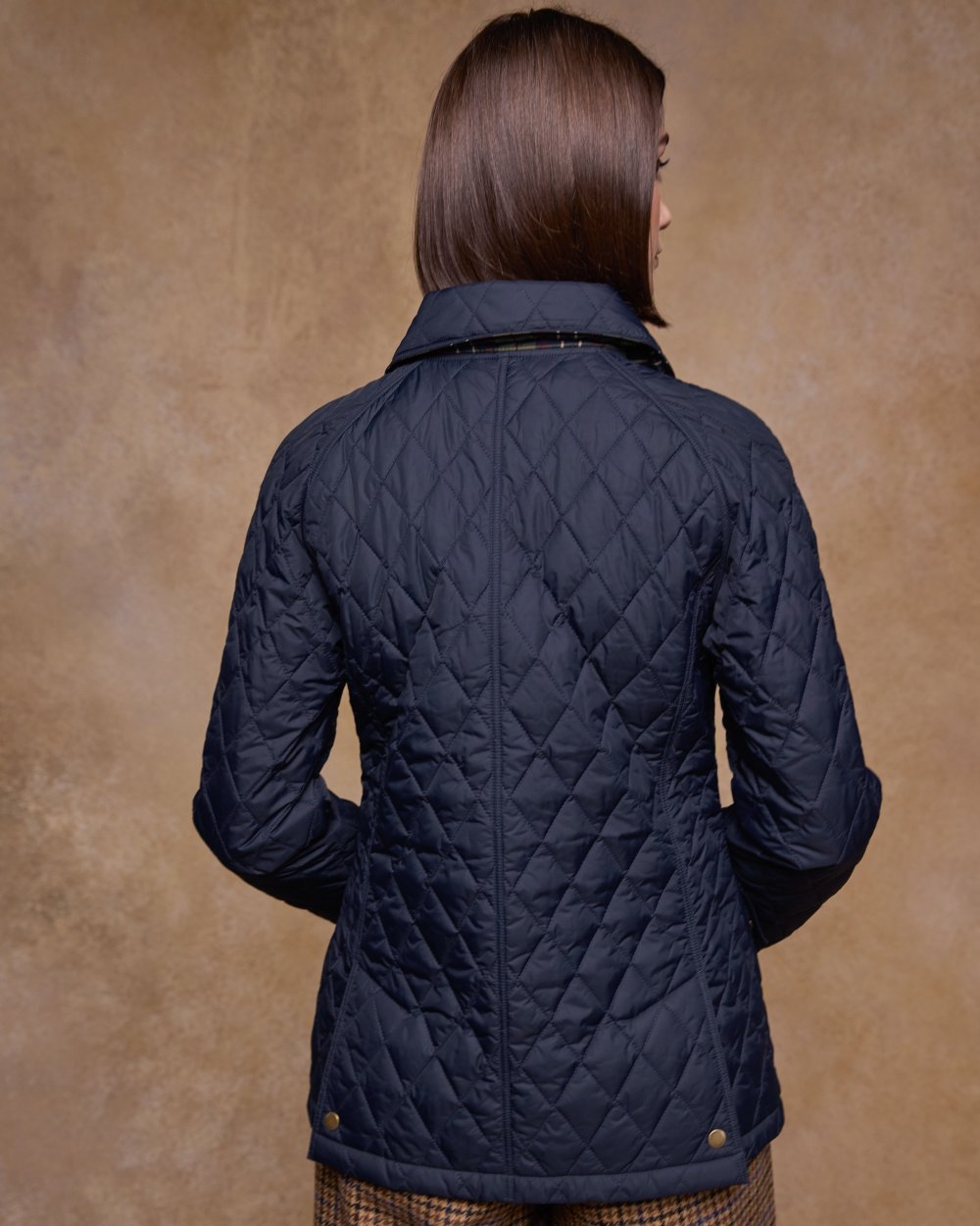 Navy coloured Jack Murphy Womens Molly Quilted Jacket on wall background