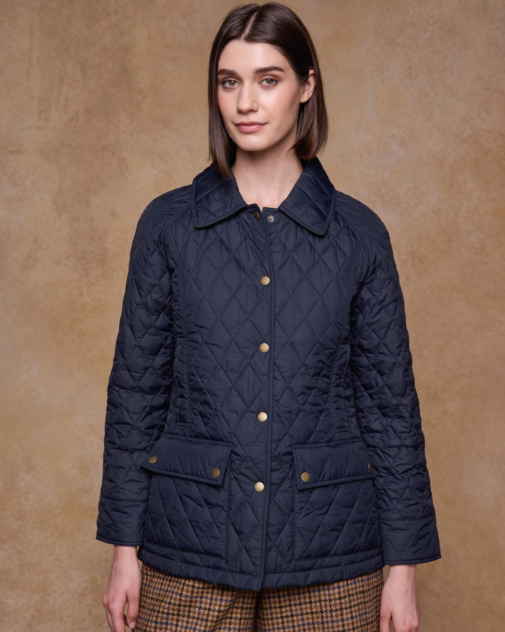 Navy coloured Jack Murphy Womens Molly Quilted Jacket on wall background