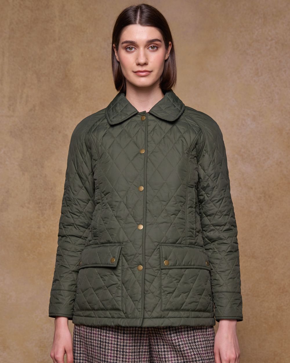 Olive coloured Jack Murphy Womens Molly Quilted Jacket on wall background