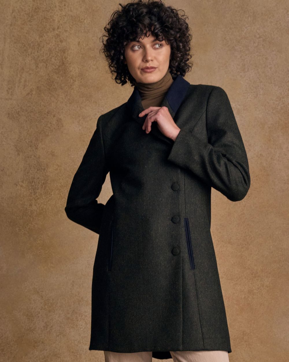 Deep Green Herringbone coloured Jack Murphy Womens Robin Tweed Coat on textured background