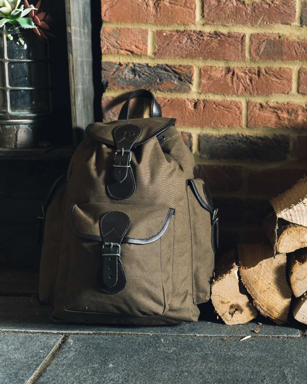 Green coloured Jack Pyke Canvas Day Pack on wall background