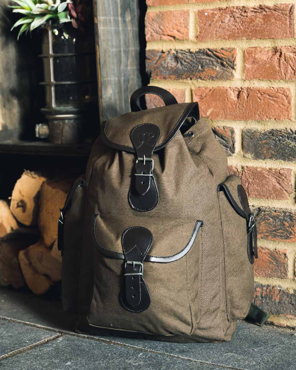 Green coloured Jack Pyke Canvas Day Pack on wall background